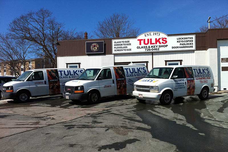 three Tulks Glass and Key Shop service vans infront of the store